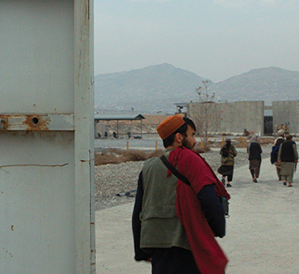 soldier in front of a stenciled metal door reading "hollywoodgate"