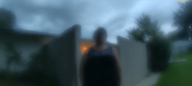 Blurry figure stepping outside from lit interior