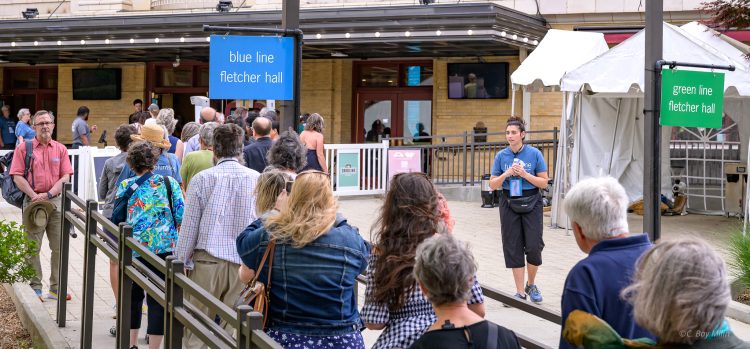 A volunteer directs traffic on the plaza