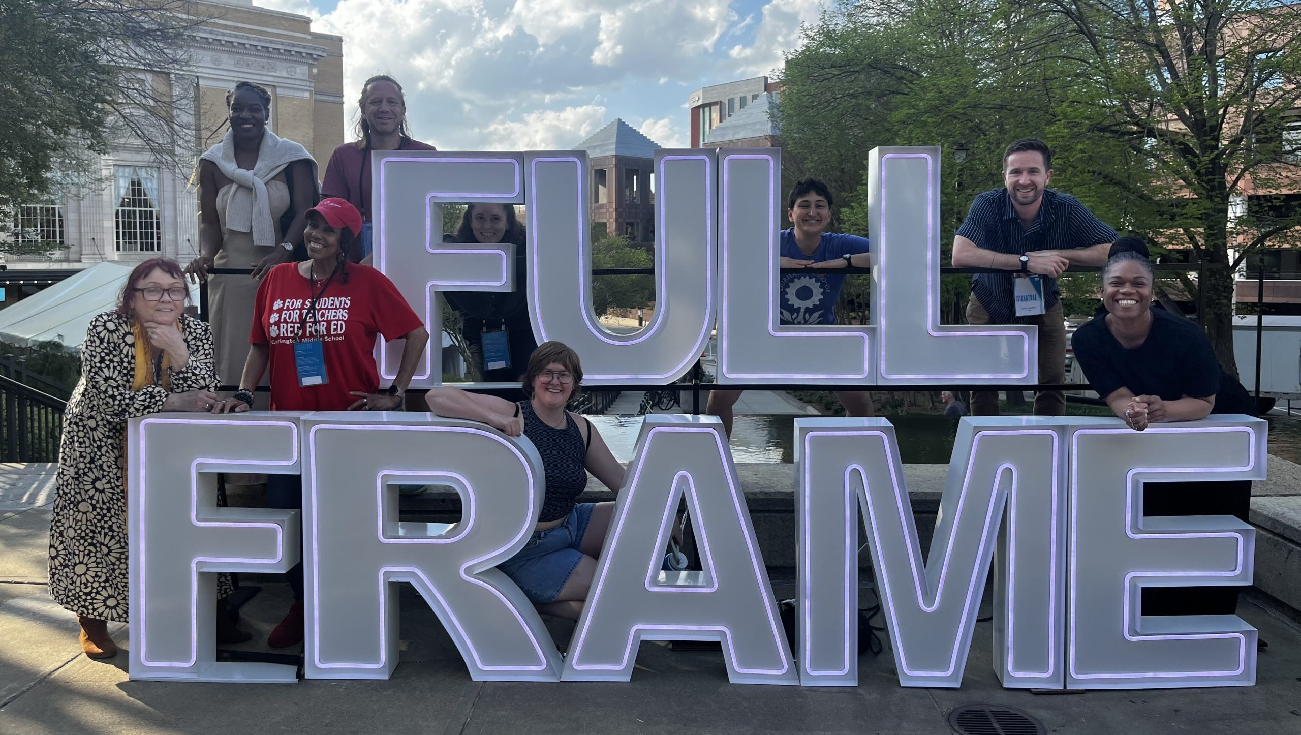 Teachers pose with the Full Frame marquee