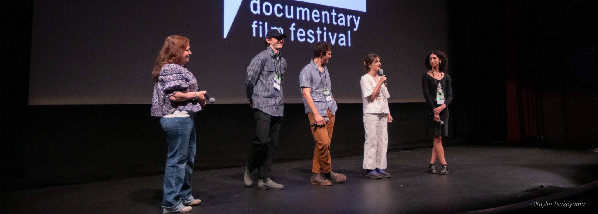 Filmmakers onstage in front of a screen bearing Full Frame logo